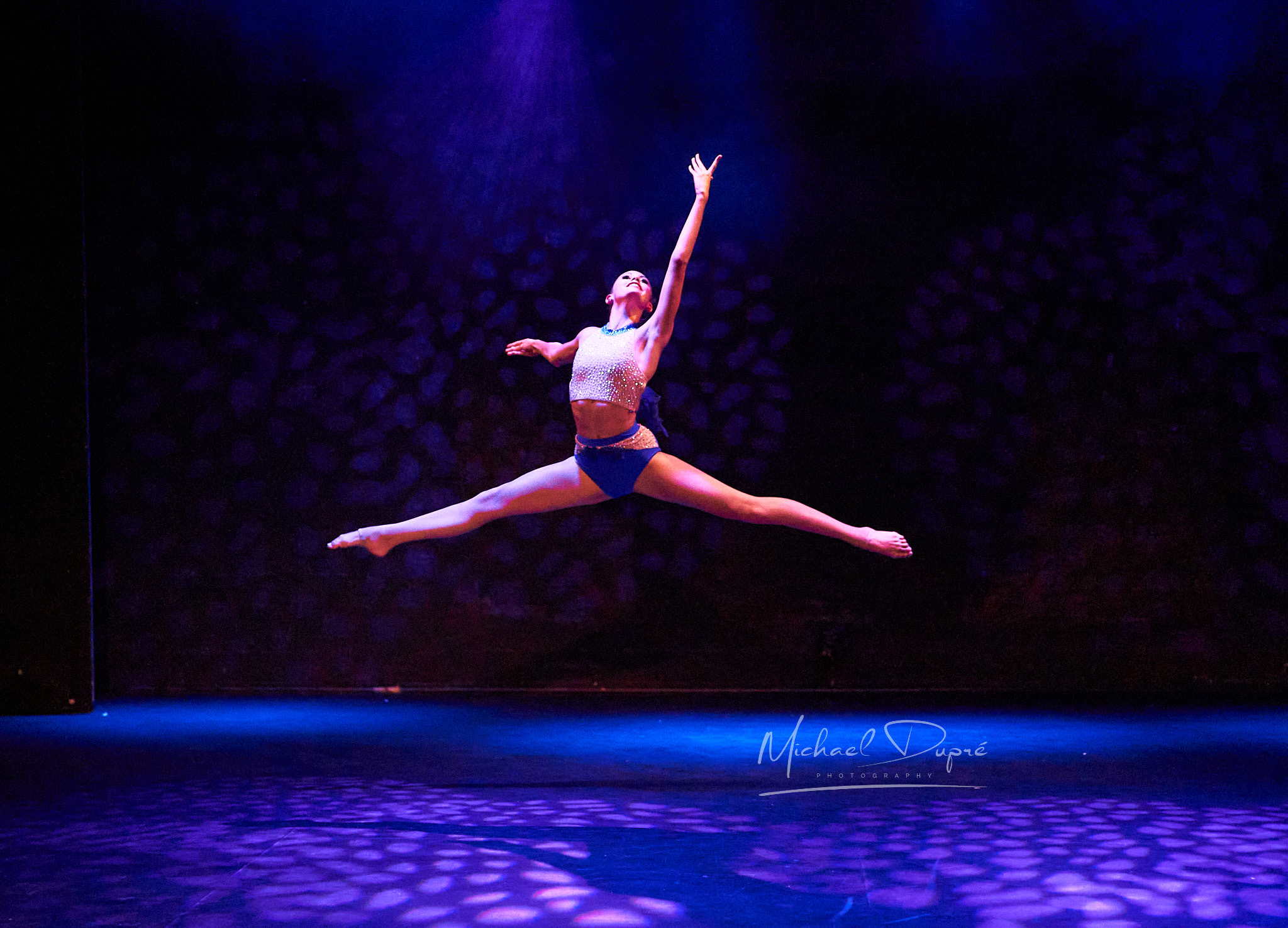 Outline Dance Centre student performing a grand jete in sparkle costume